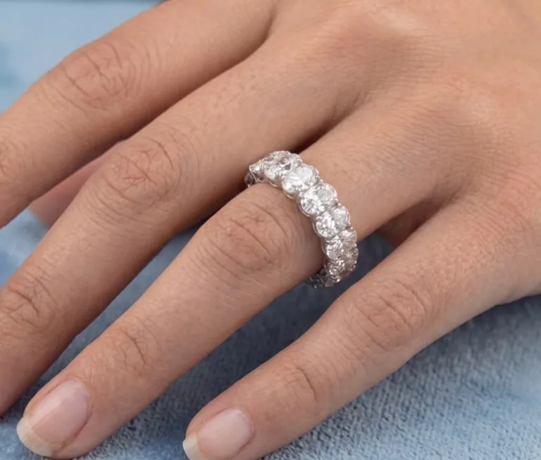 A platinum oval-cut eternity ring worn on the hand