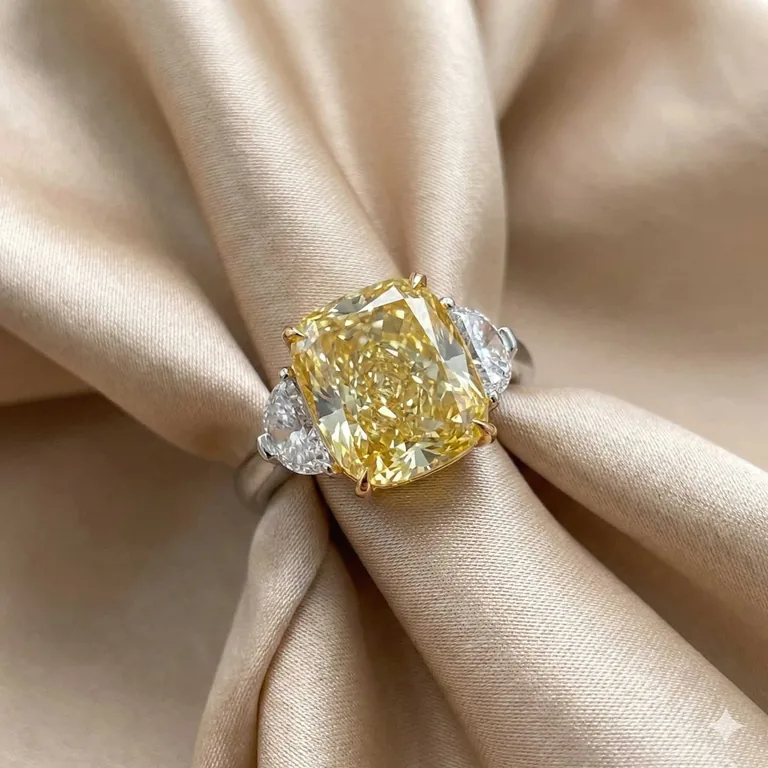 A fancy intense yellow radiant-cut diamond ring in platinum